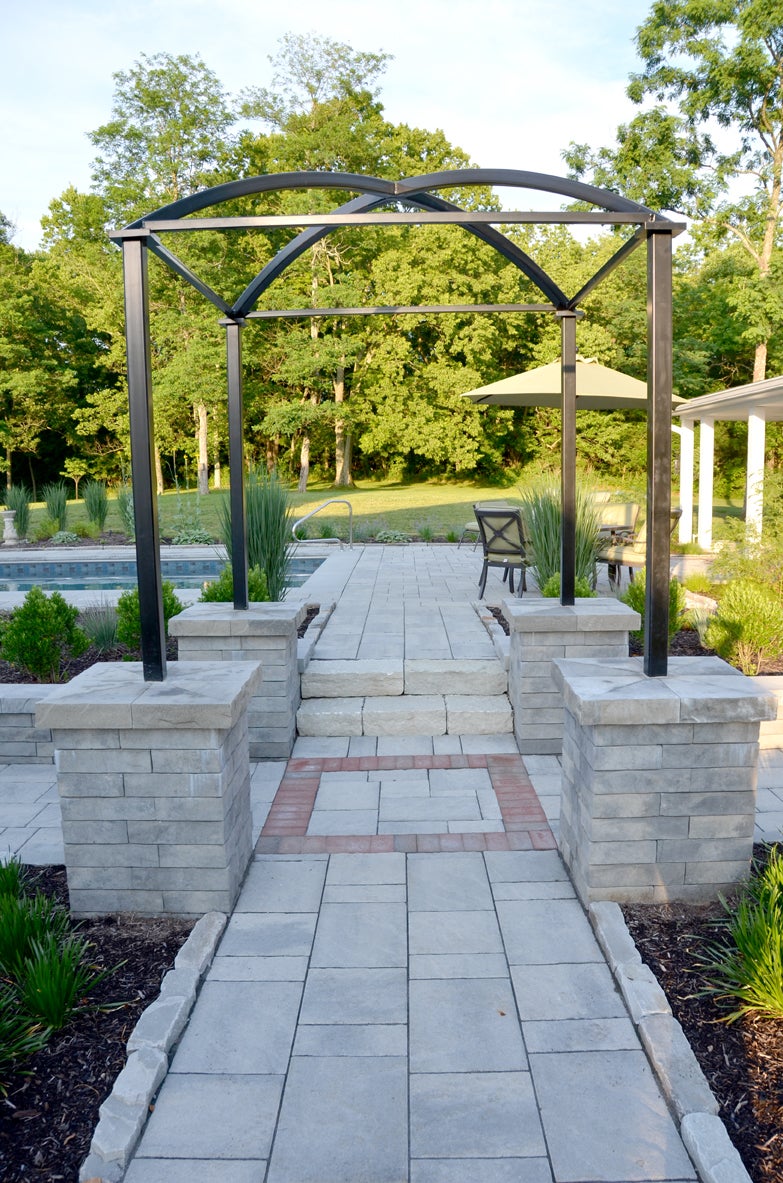 Create an inviting entrance with pavers, brick and stone