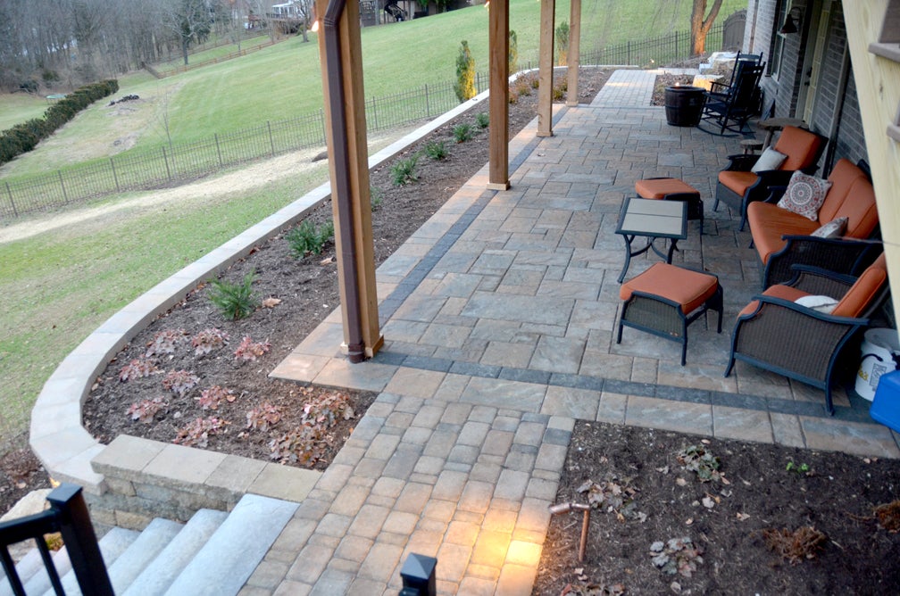 Create an inviting entrance with pavers, brick and stone